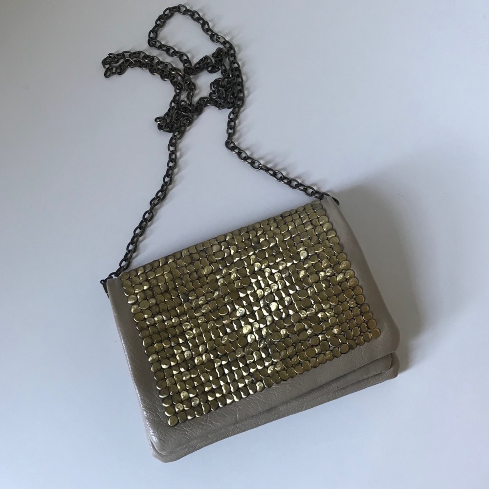 Tan bag with gold embellishment on outside